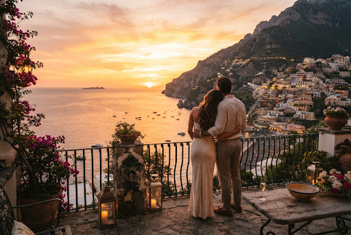 A breathtaking, high-end lifestyle photograph of a couple watching a golden sunset over the Amalfi Coast.